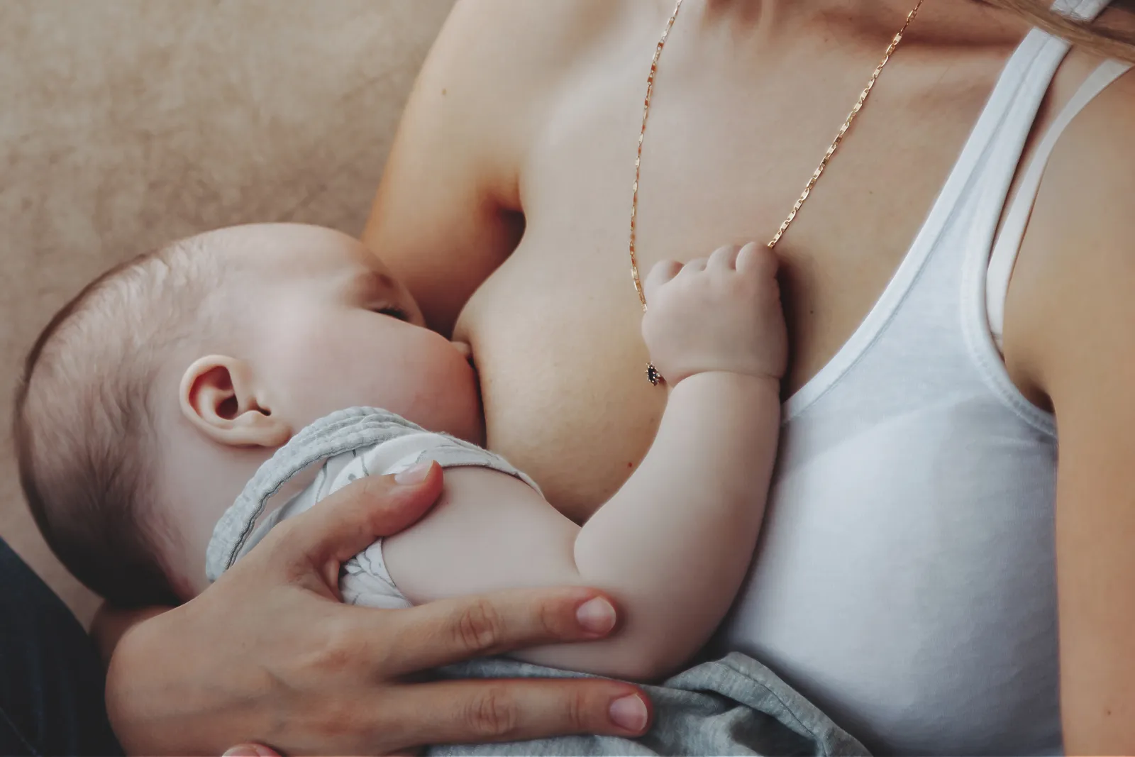 infant-nursing-peacefully-in-mother-s-arms